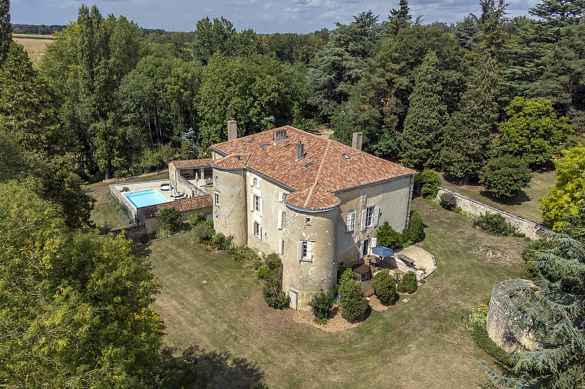 Aerial view of a French château retreat venue with swimming pool